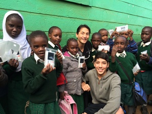 Dr. Marco and one of his sons with the Kibera school children and their new Luminaid lamps