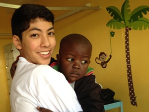 Dr. Marco's middle son playing with a pediatric patient